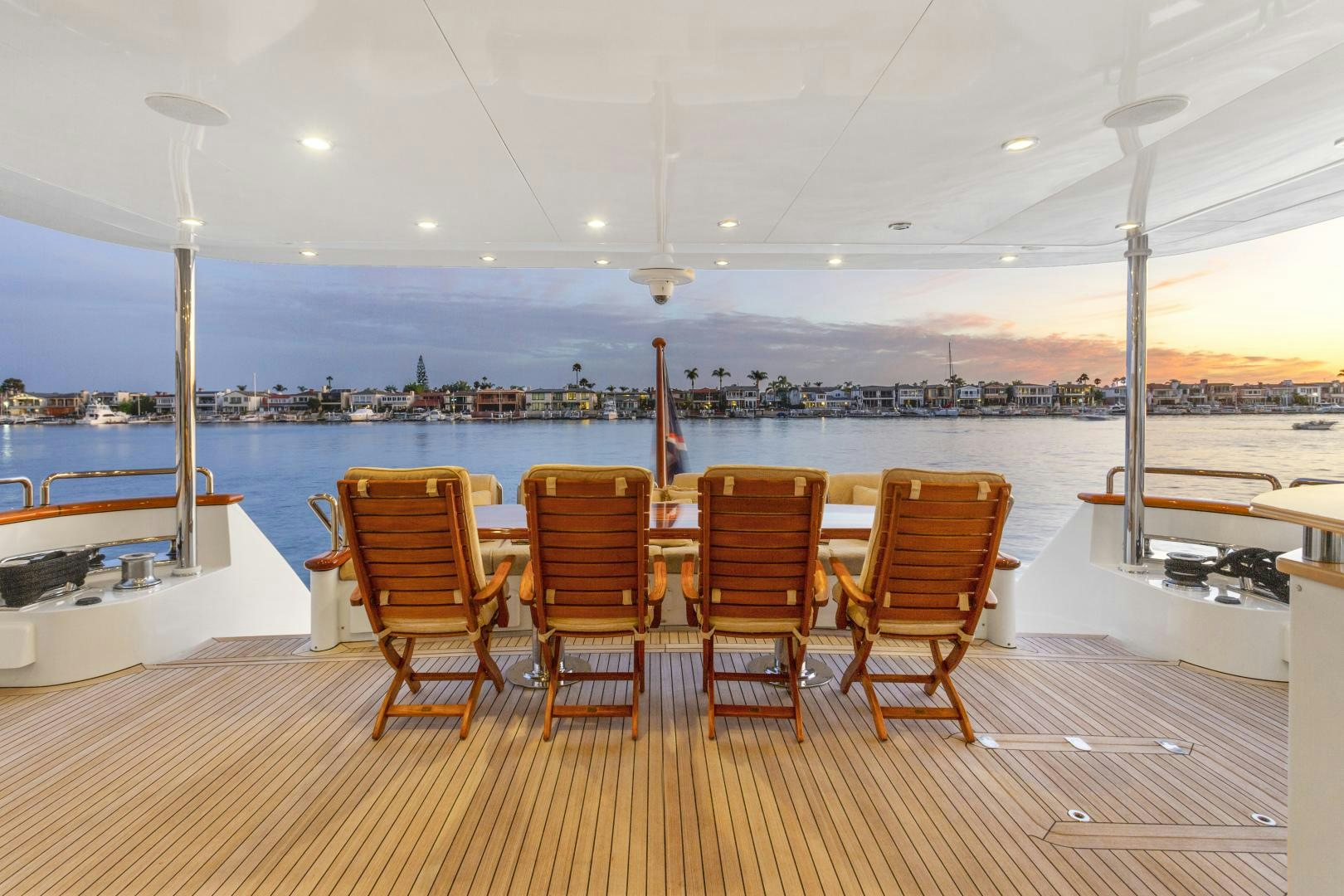 a group of chairs on a deck overlooking a city aboard ANA’S INSPIRATION Yacht for Sale