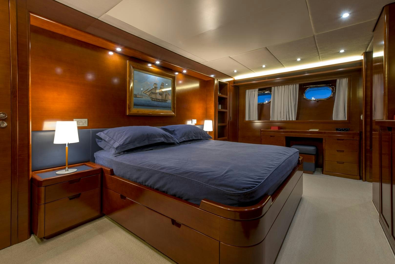 a bedroom with a bed and desk aboard GIOIA 1 Yacht for Sale