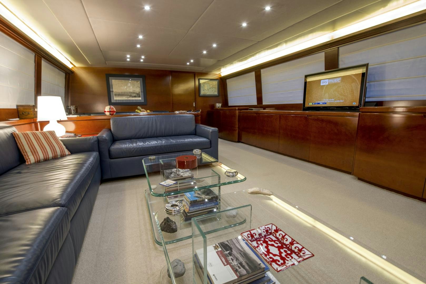a living room with a large sofa and a coffee table aboard GIOIA 1 Yacht for Sale