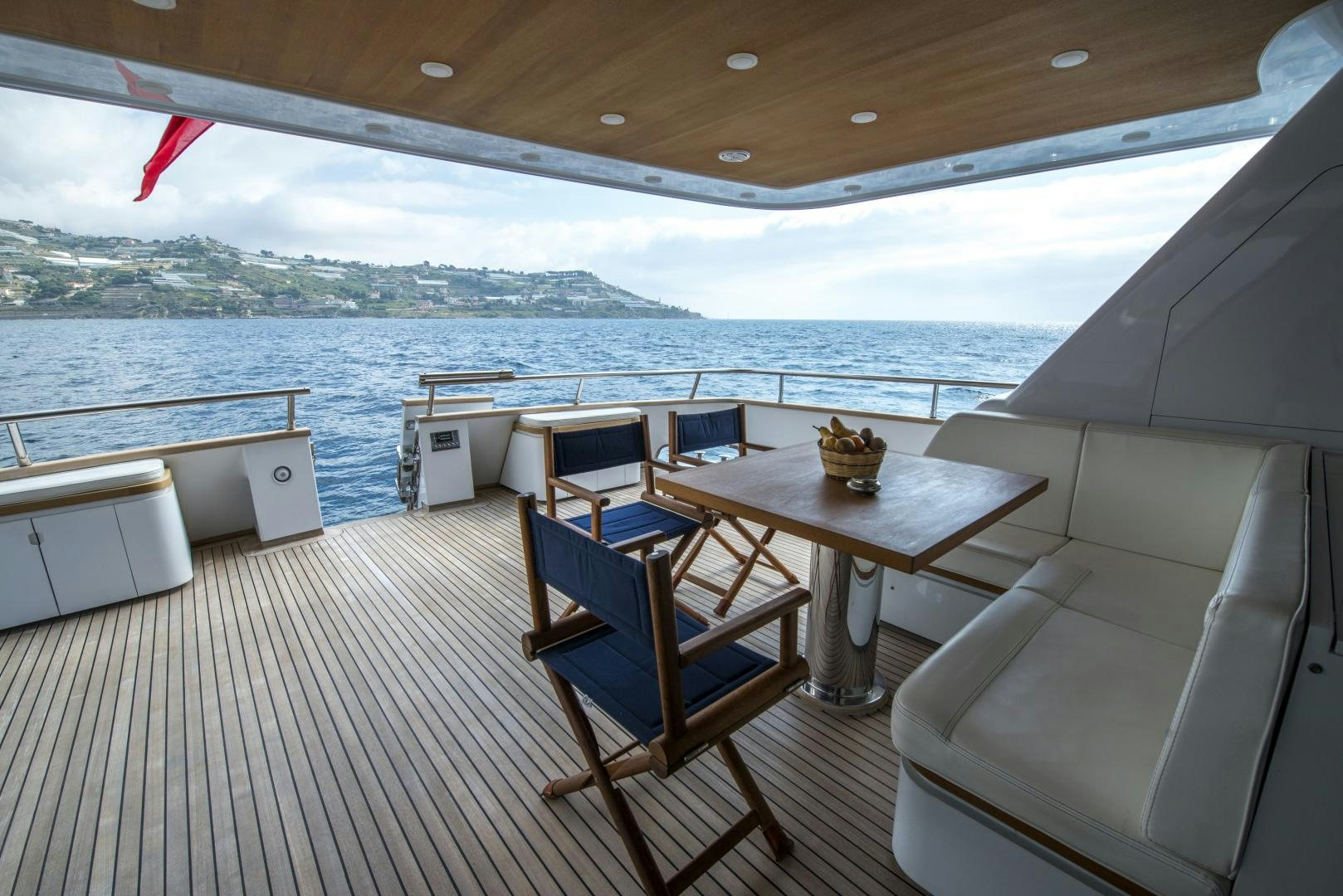 a deck with a table and chairs on it aboard GIOIA 1 Yacht for Sale