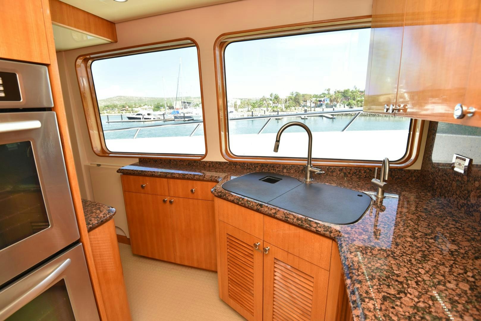 a kitchen with a sink and a window aboard BLUE STEELE Yacht for Sale