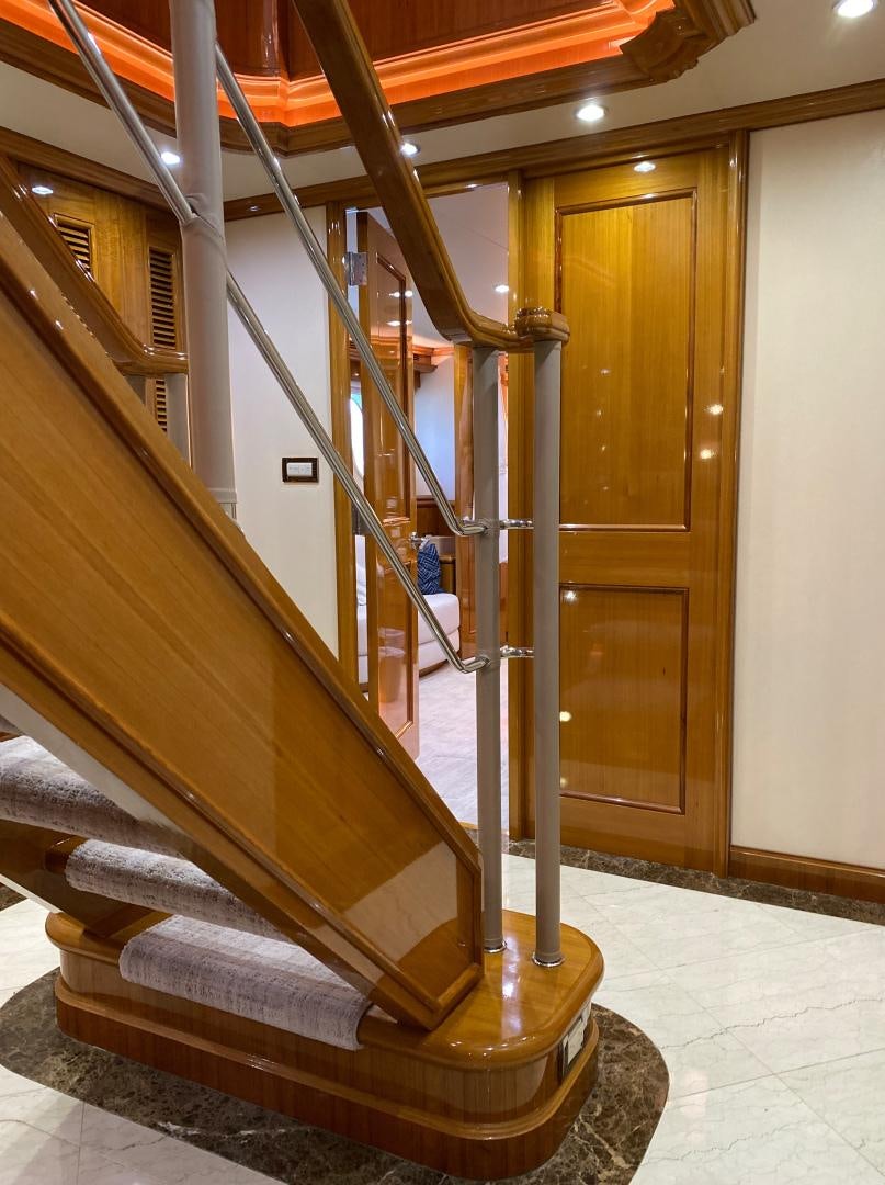 a staircase with wood railings aboard BLUE STEELE Yacht for Sale