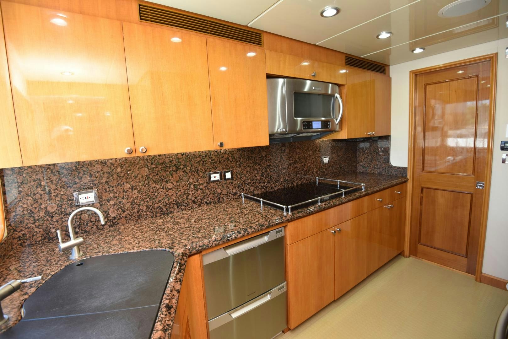 a kitchen with wooden cabinets aboard BLUE STEELE Yacht for Sale
