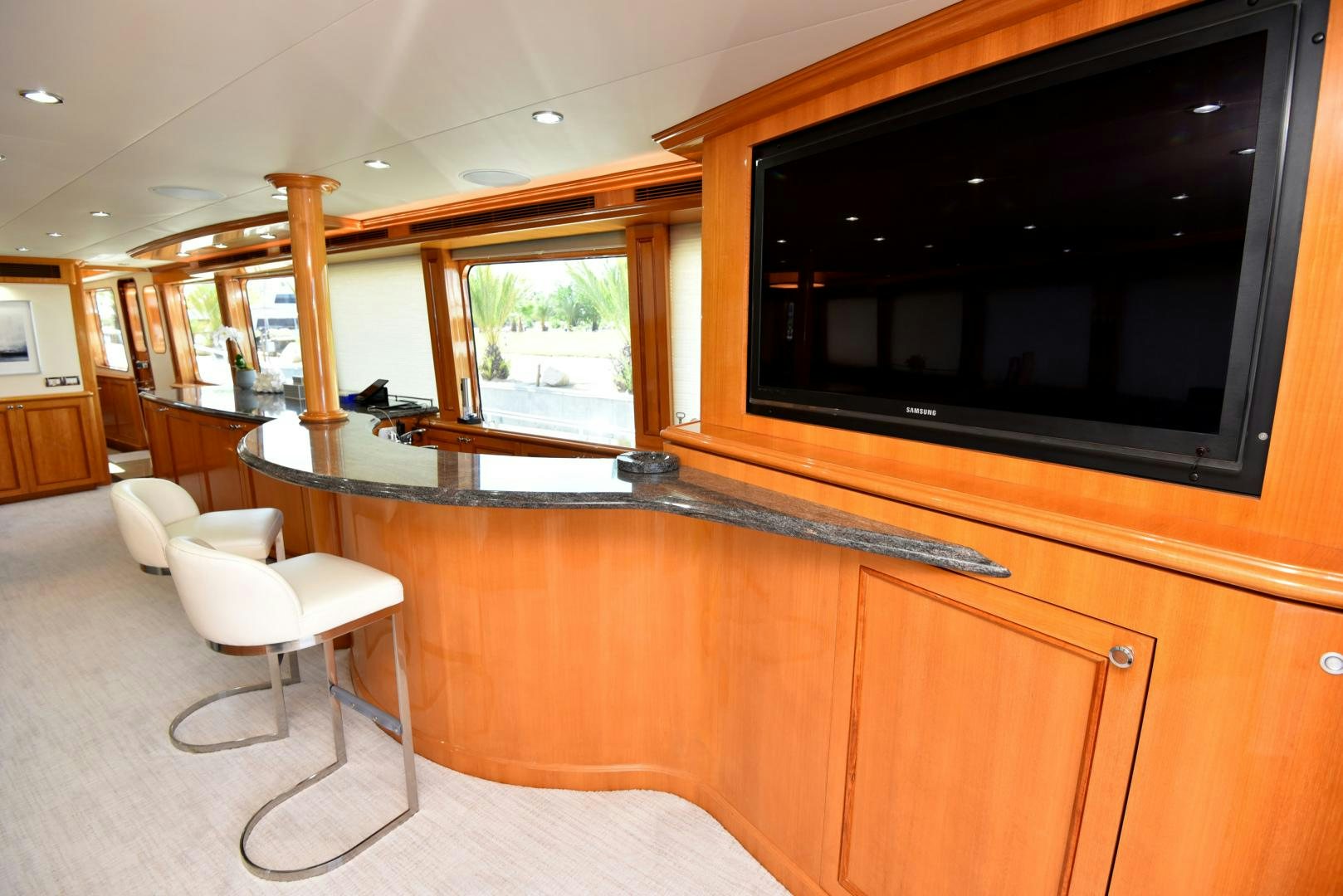 a room with a tv and chairs aboard BLUE STEELE Yacht for Sale