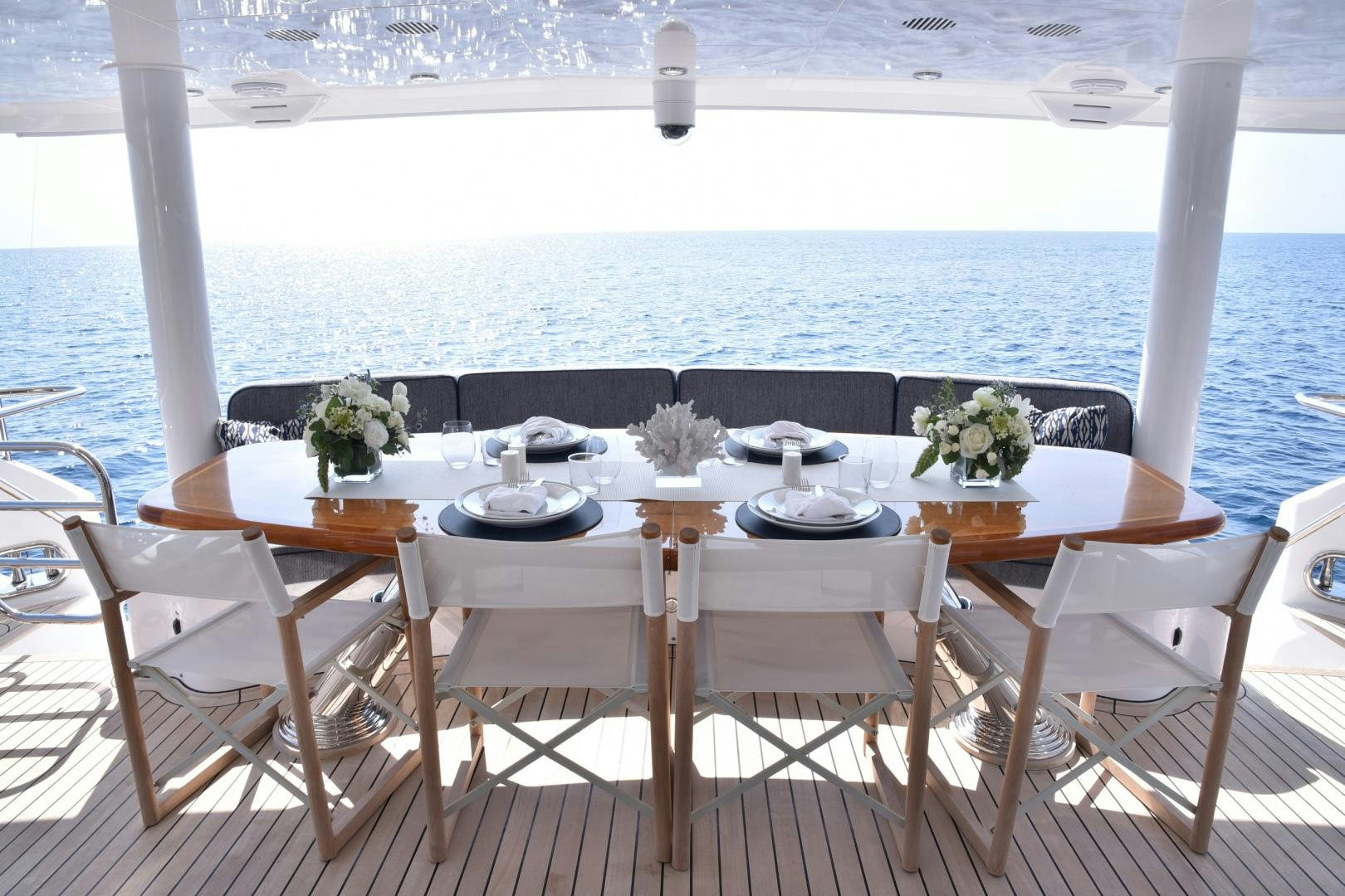 a table set for a meal on a deck overlooking the ocean aboard BLUE STEELE Yacht for Sale