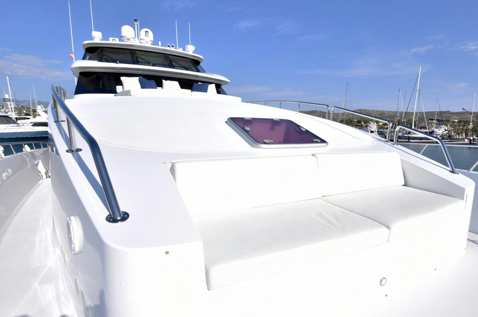 a white yacht in a harbor aboard BLUE STEELE Yacht for Sale