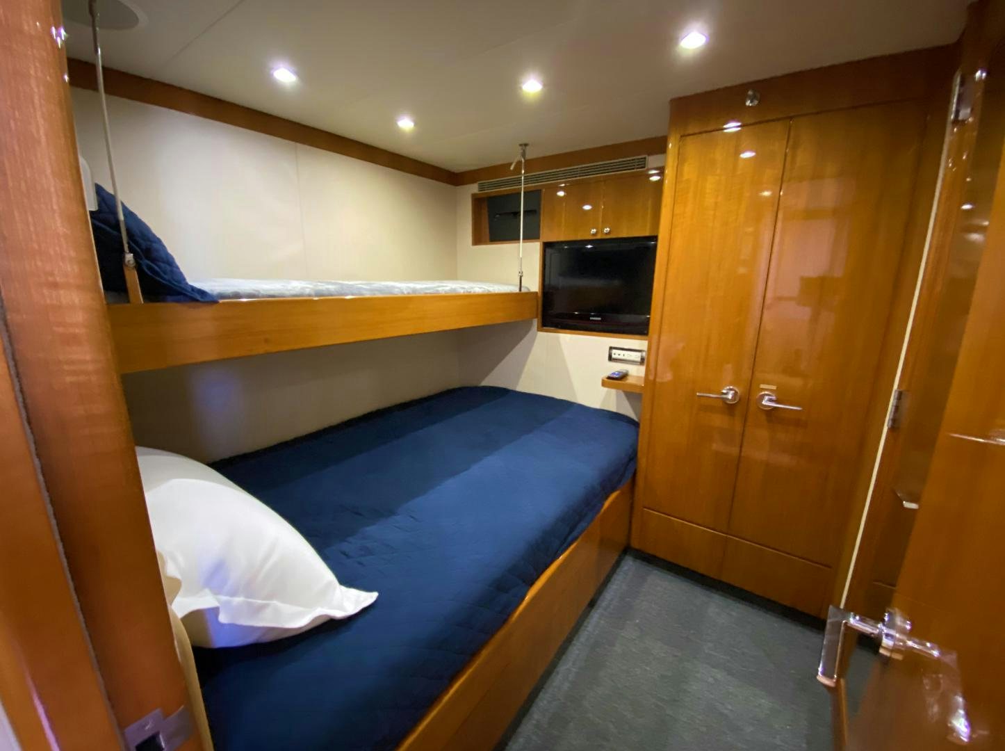 a room with a bed and a wood door aboard BLUE STEELE Yacht for Sale