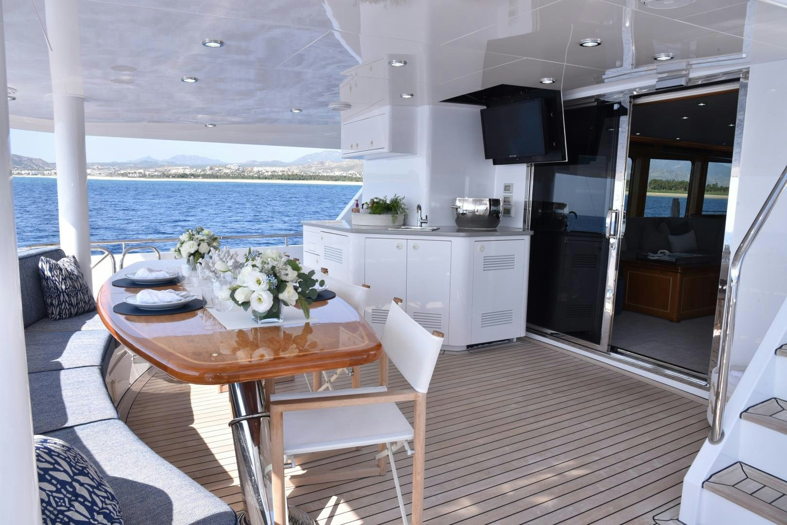 a table and chairs on a deck aboard BLUE STEELE Yacht for Sale