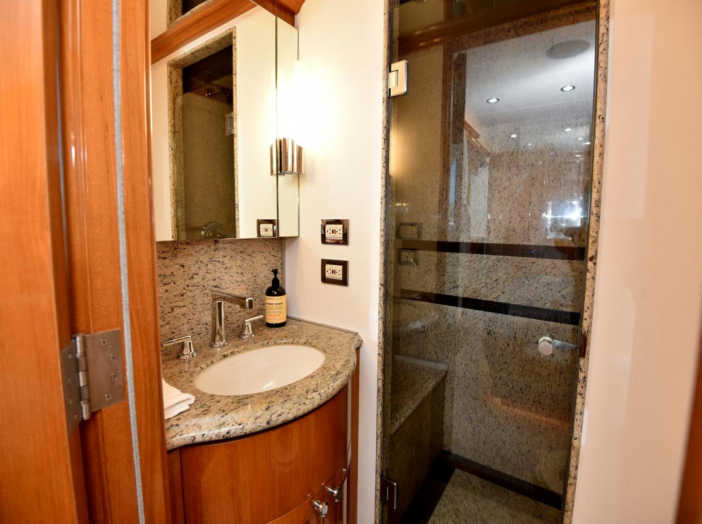 a bathroom with a glass shower door aboard BLUE STEELE Yacht for Sale