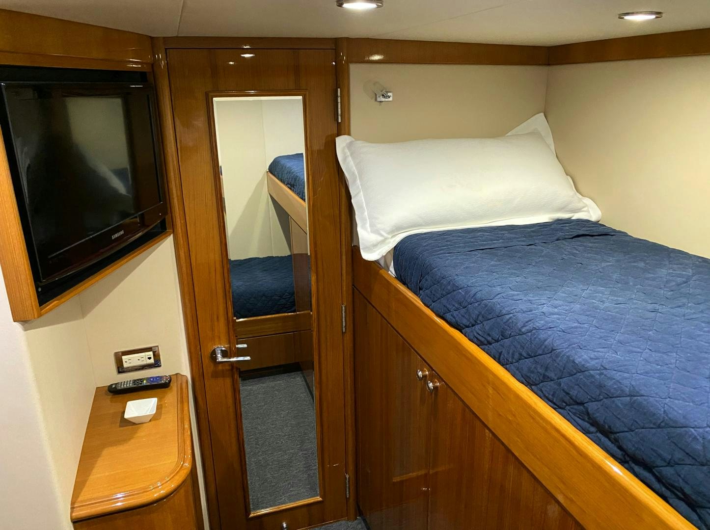 a bed with a television on the wall aboard BLUE STEELE Yacht for Sale