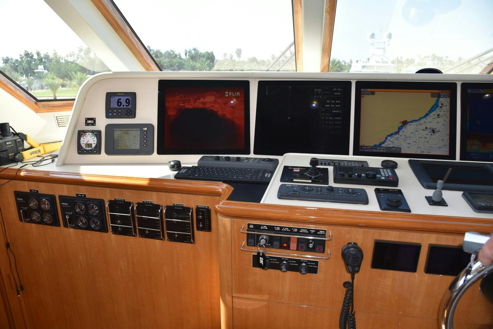 a wooden desk with a computer and other electronic devices on it aboard BLUE STEELE Yacht for Sale