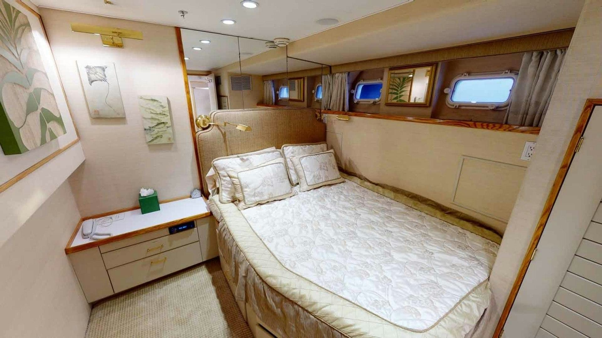 a room with a bed and a desk aboard LORELEI Yacht for Sale
