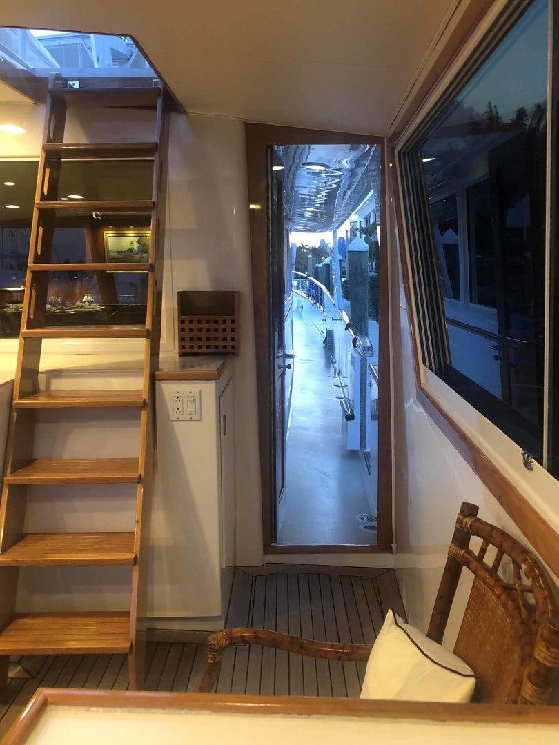 a room with a wood door and a window with a wood frame aboard LORELEI Yacht for Sale