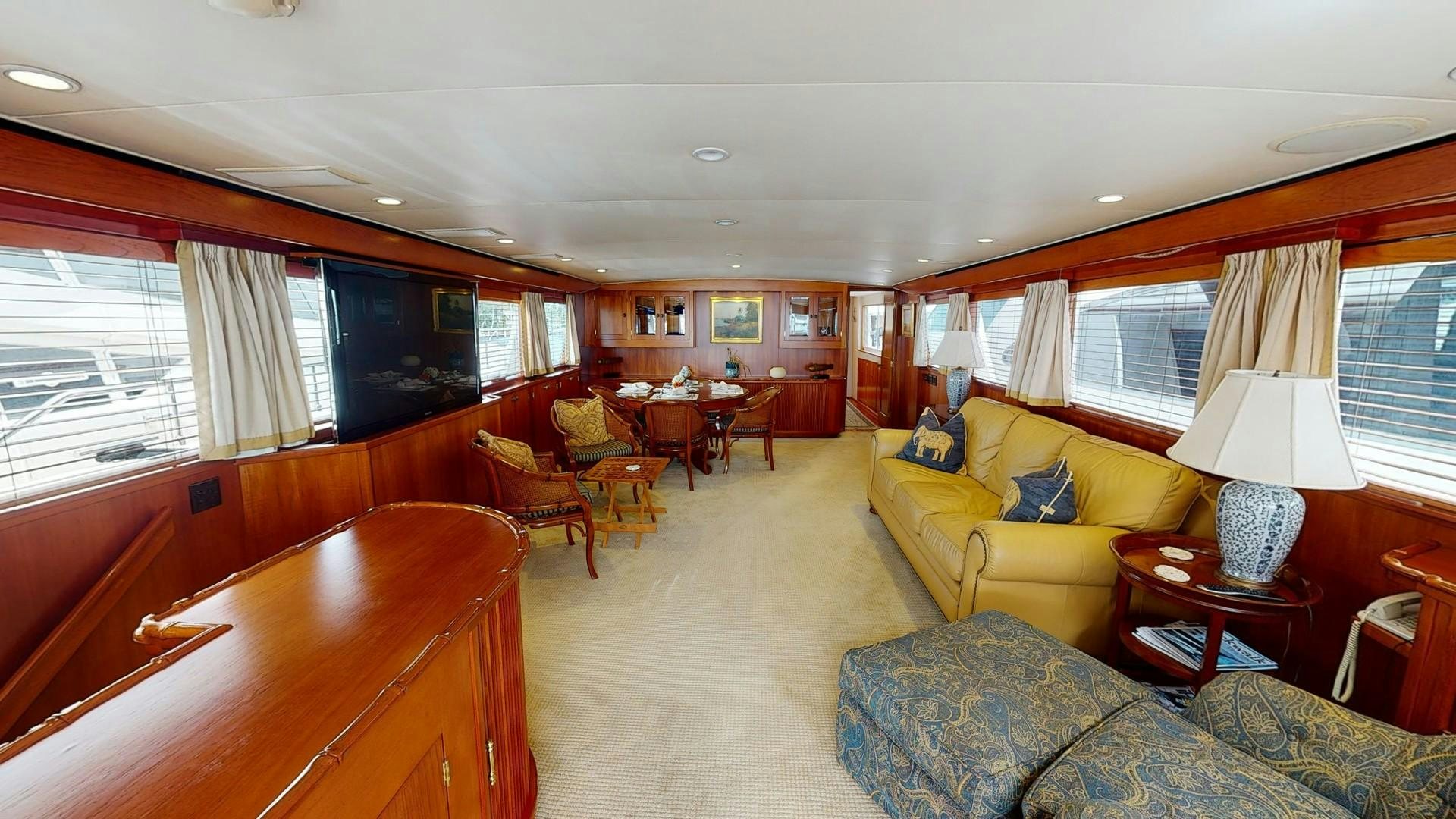 a living room with a yellow couch aboard LORELEI Yacht for Sale