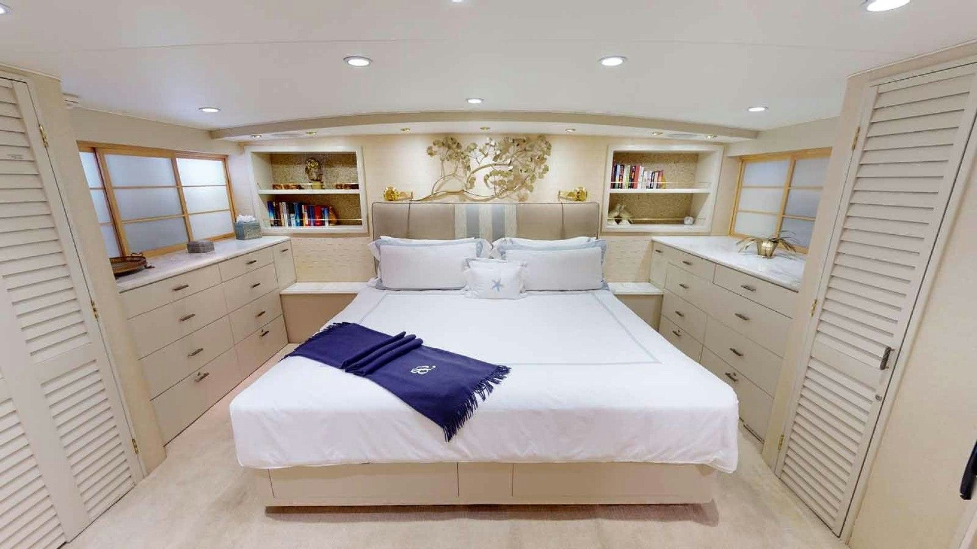 a bedroom with a bed and a dresser aboard LORELEI Yacht for Sale