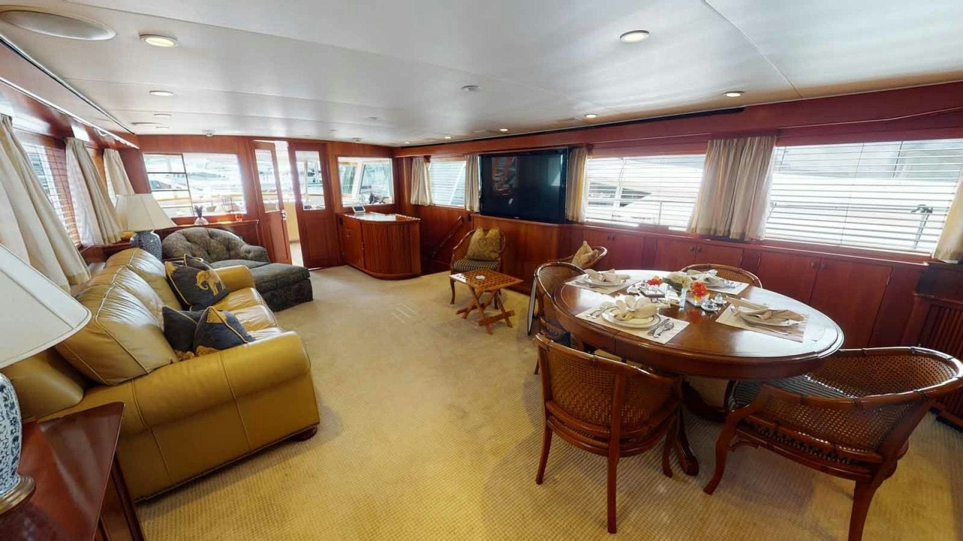 a living room with a table and chairs aboard LORELEI Yacht for Sale