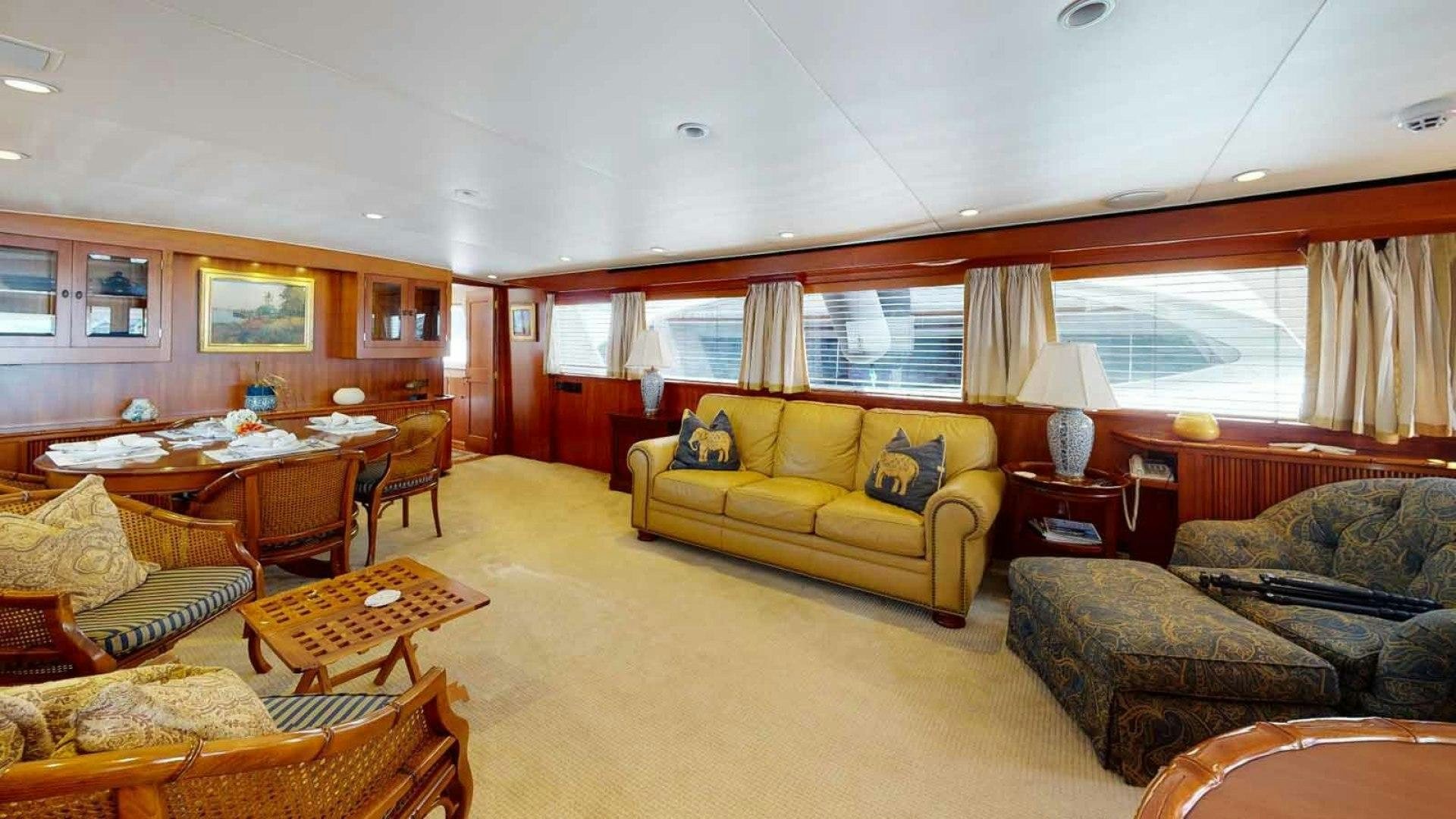 a living room with a couch and a table aboard LORELEI Yacht for Sale