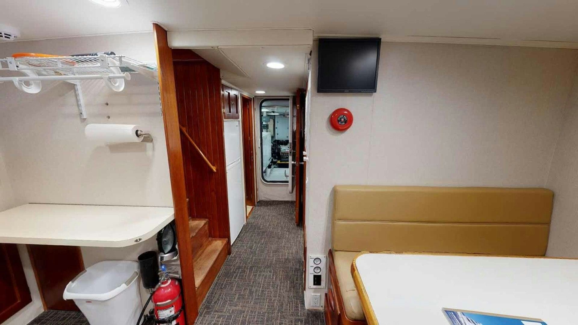 a room with a bed and a tv on the wall aboard LORELEI Yacht for Sale