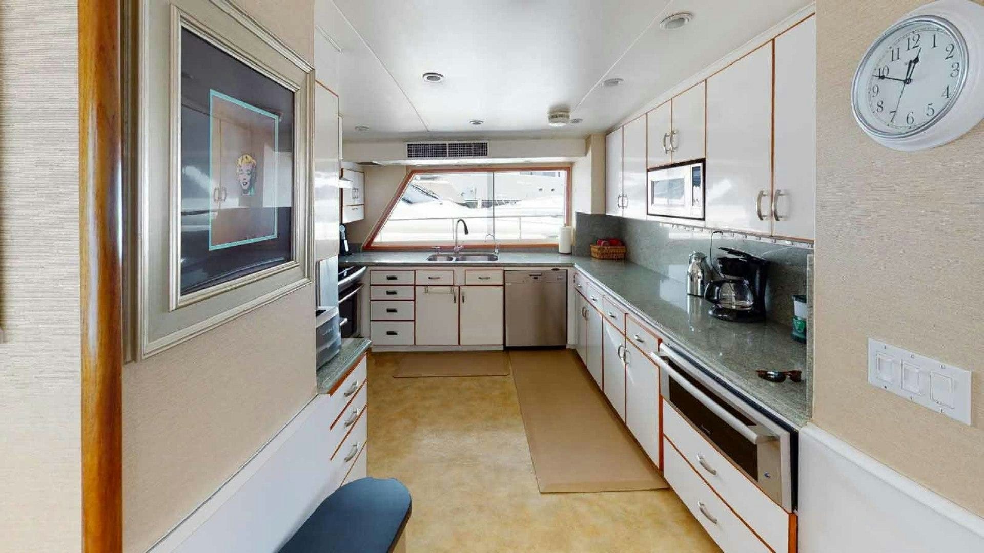 a kitchen with a large window aboard LORELEI Yacht for Sale