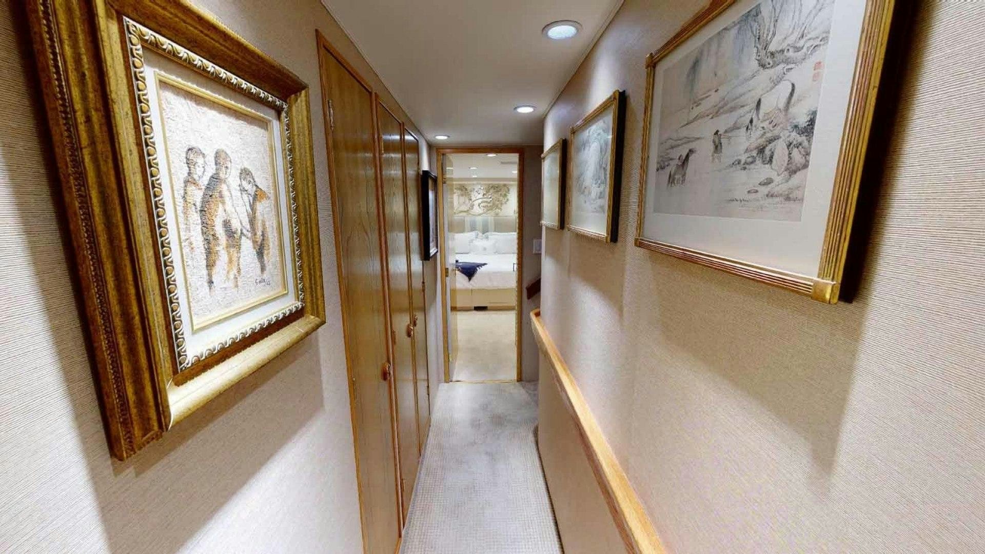 a hallway with paintings on the wall aboard LORELEI Yacht for Sale