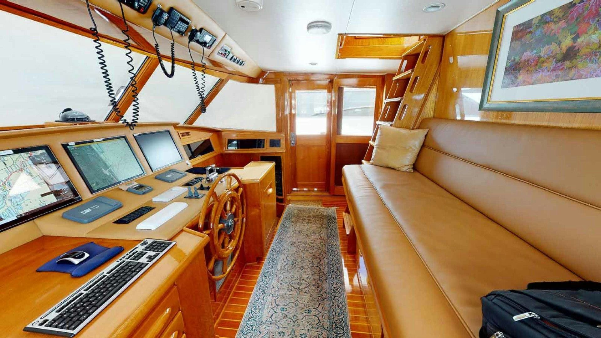 a room with a couch and a desk with computers on it aboard LORELEI Yacht for Sale
