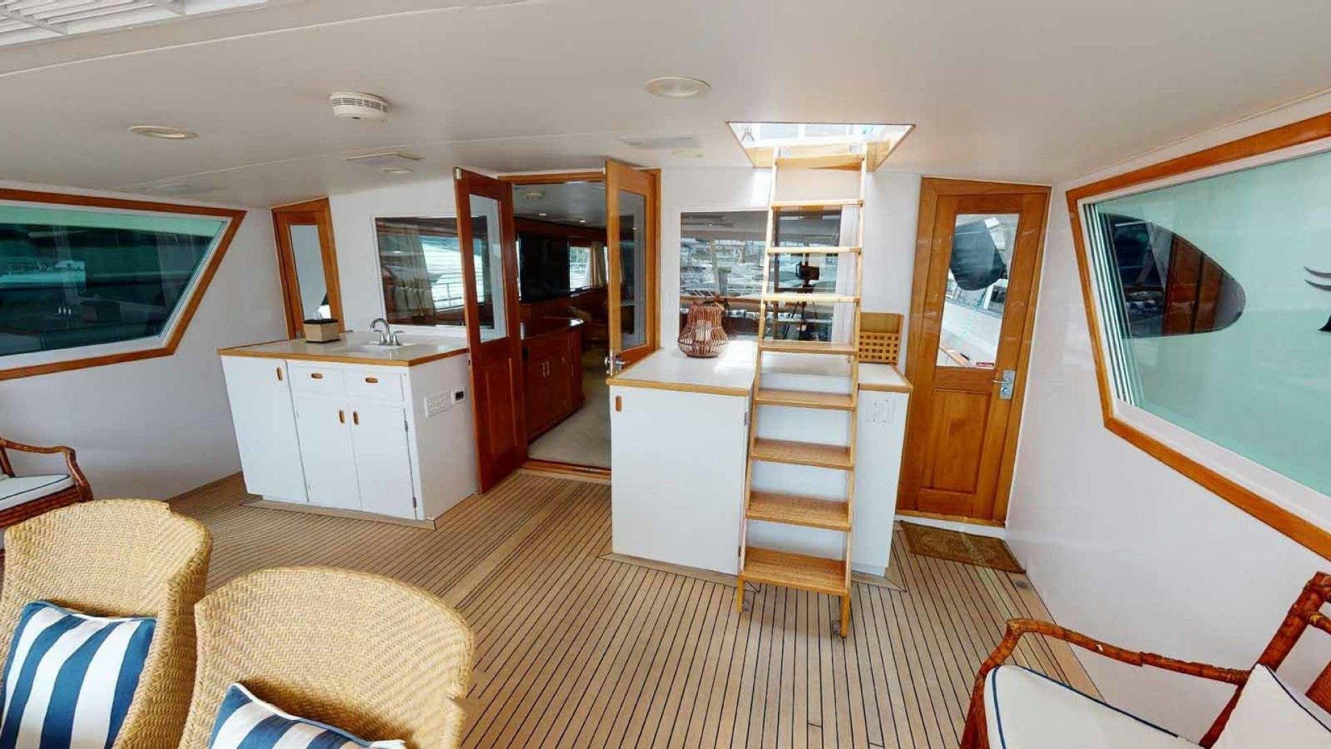 a living room with a bookcase aboard LORELEI Yacht for Sale