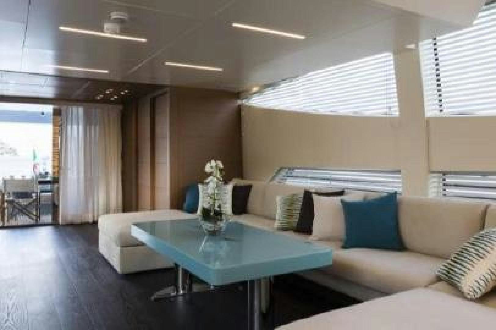 a living room with a couch and a table aboard No Name Yacht for Sale