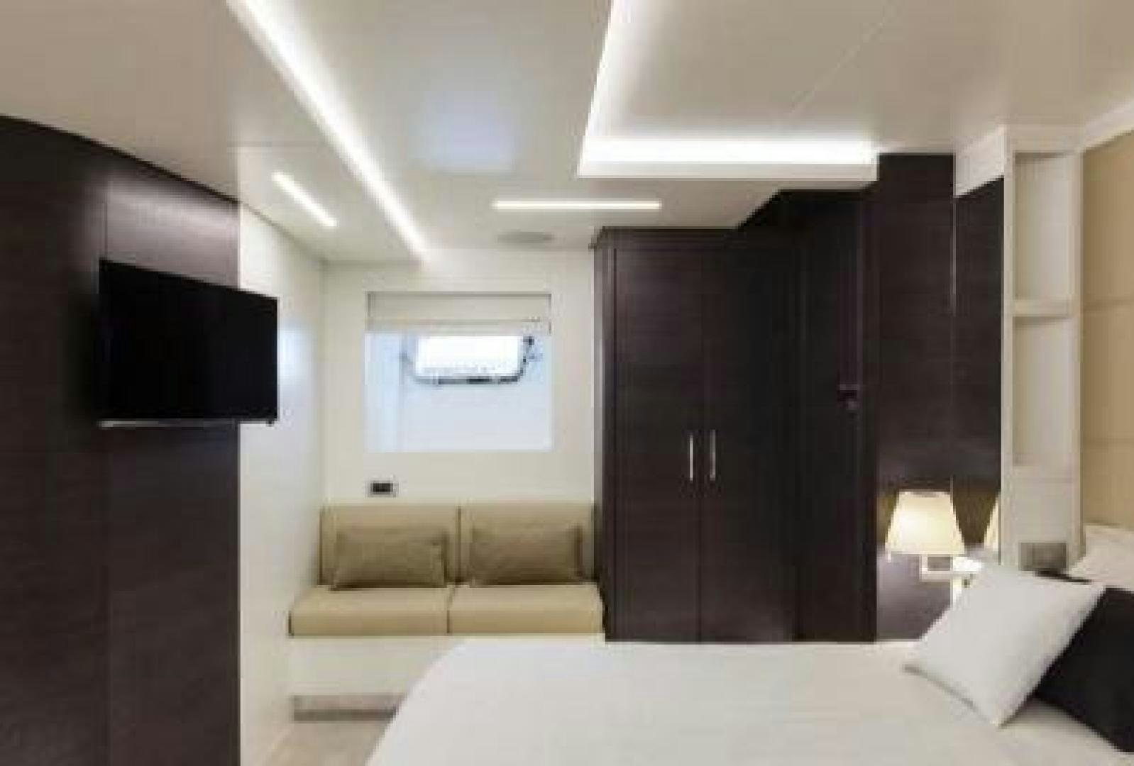 a room with a bed and a tv aboard No Name Yacht for Sale