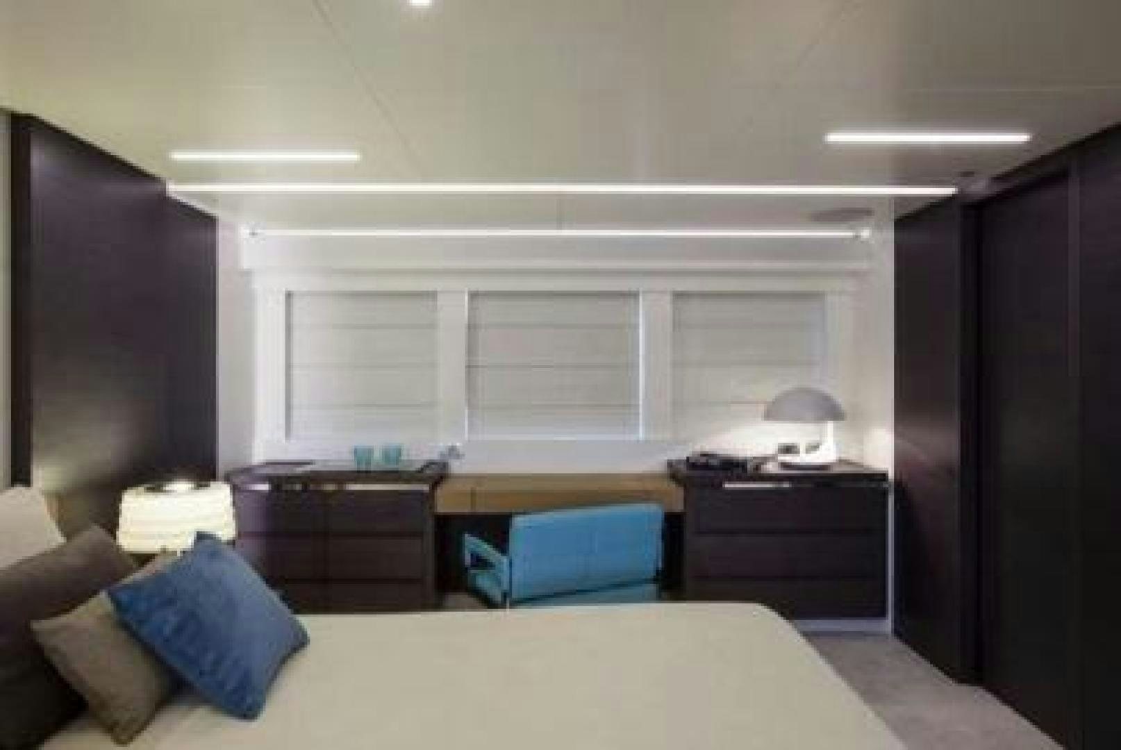 a bedroom with a bed and a desk aboard No Name Yacht for Sale