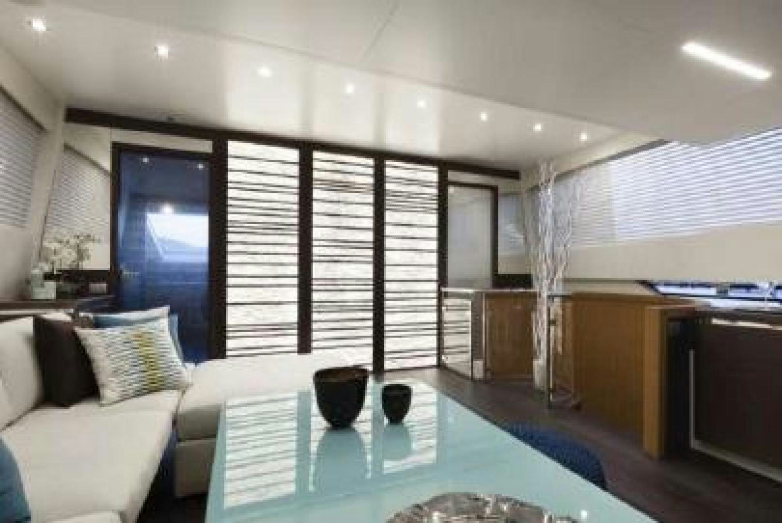 a room with a table and a couch aboard No Name Yacht for Sale