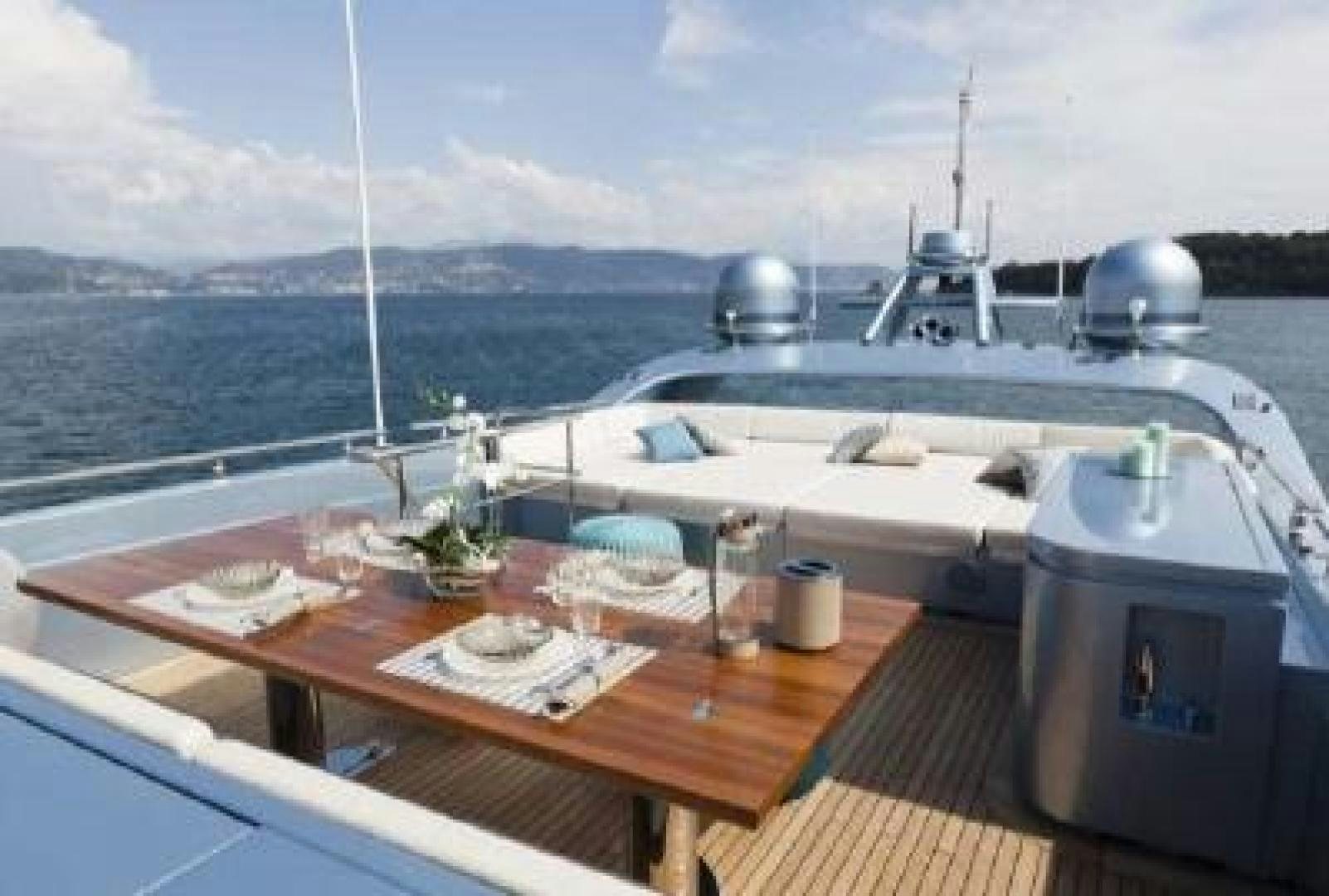 a table with a planter on it and a view of the ocean aboard No Name Yacht for Sale