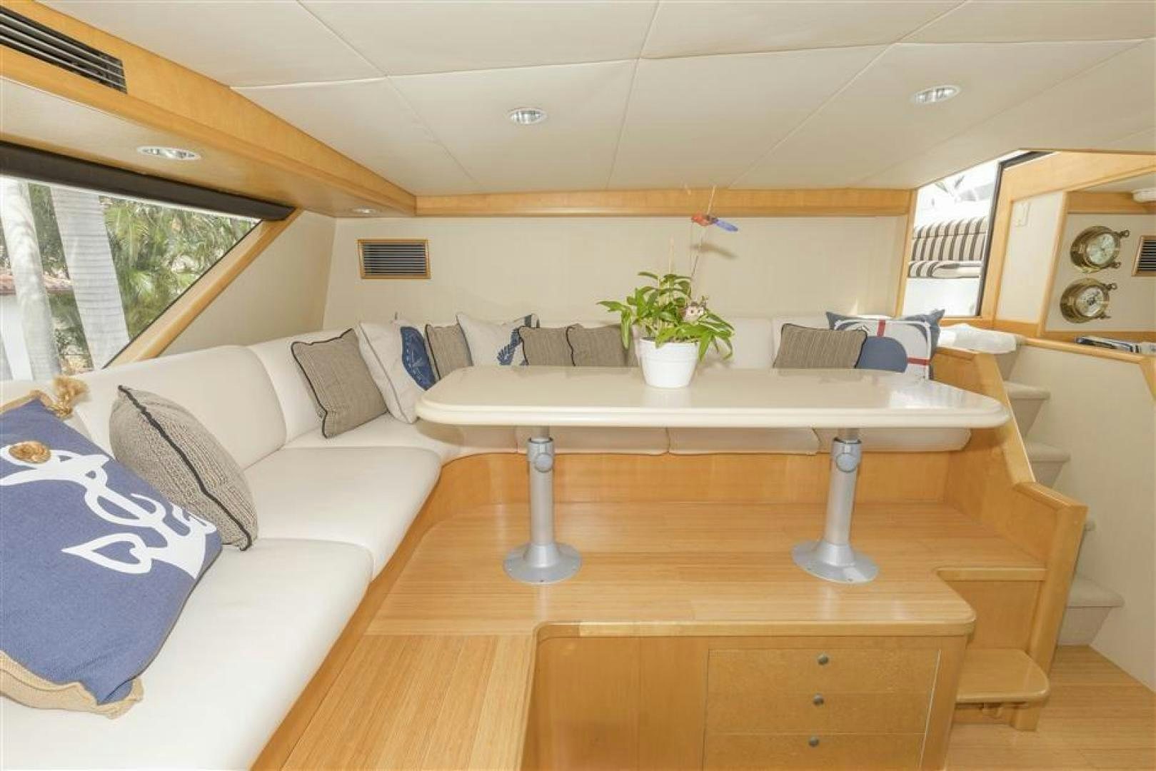 a living room with a white couch and a coffee table aboard DETERMINATION Yacht for Sale