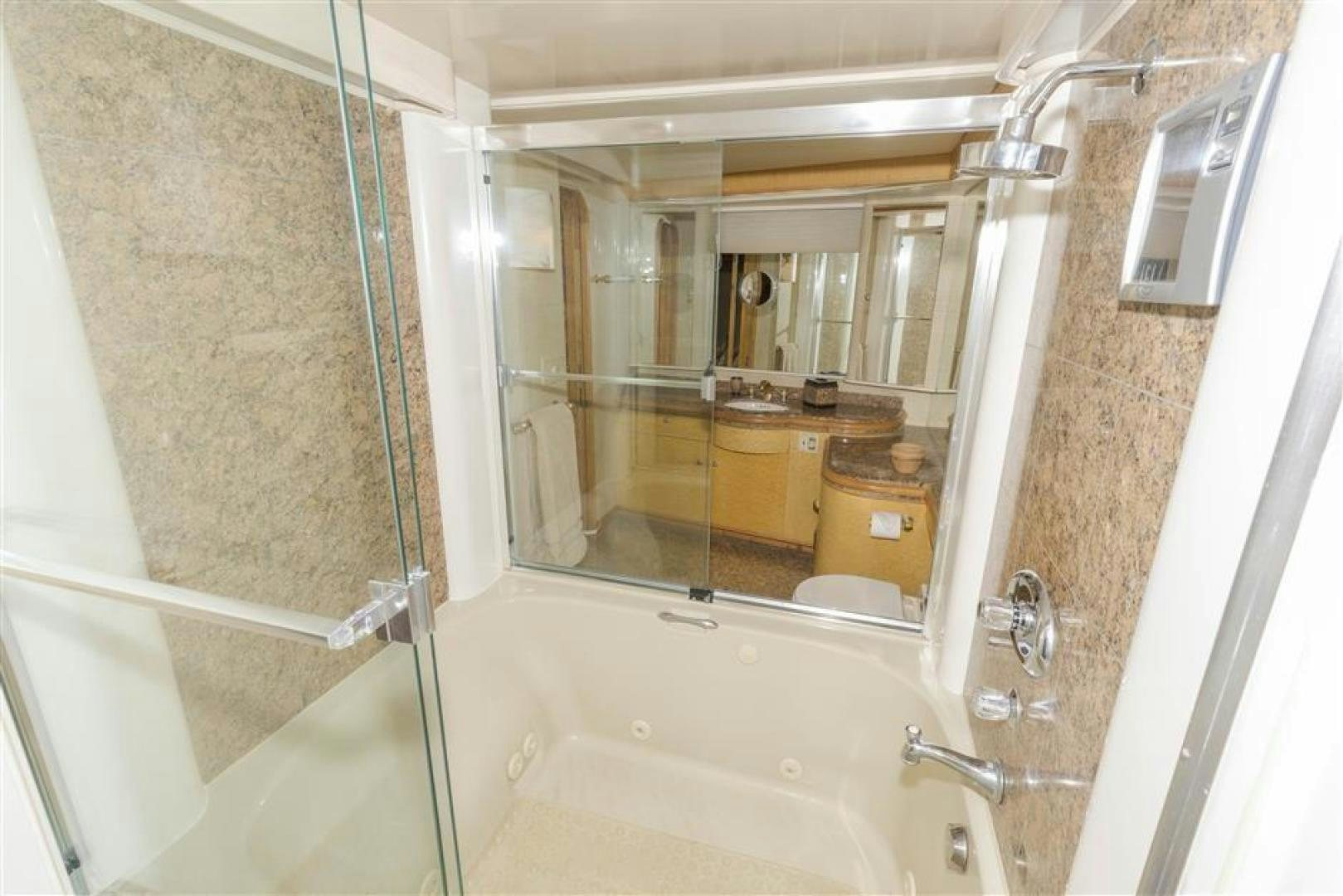 a bathroom with a tub and shower aboard DETERMINATION Yacht for Sale