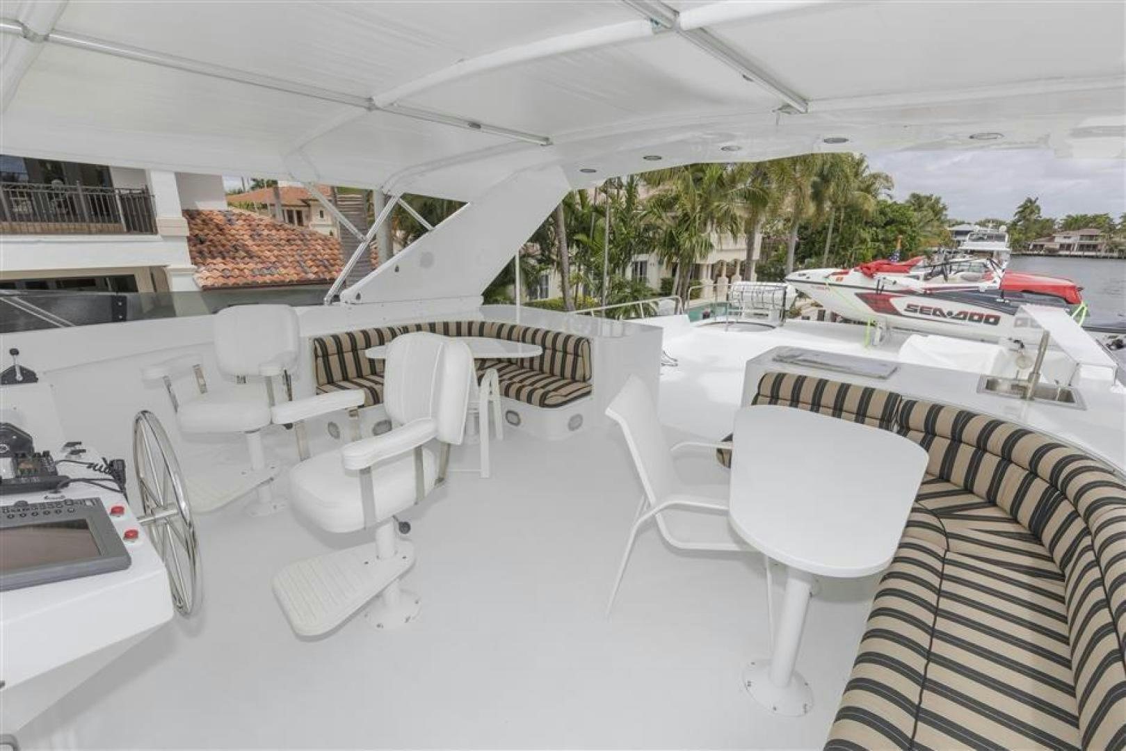 a room with white chairs and tables aboard DETERMINATION Yacht for Sale