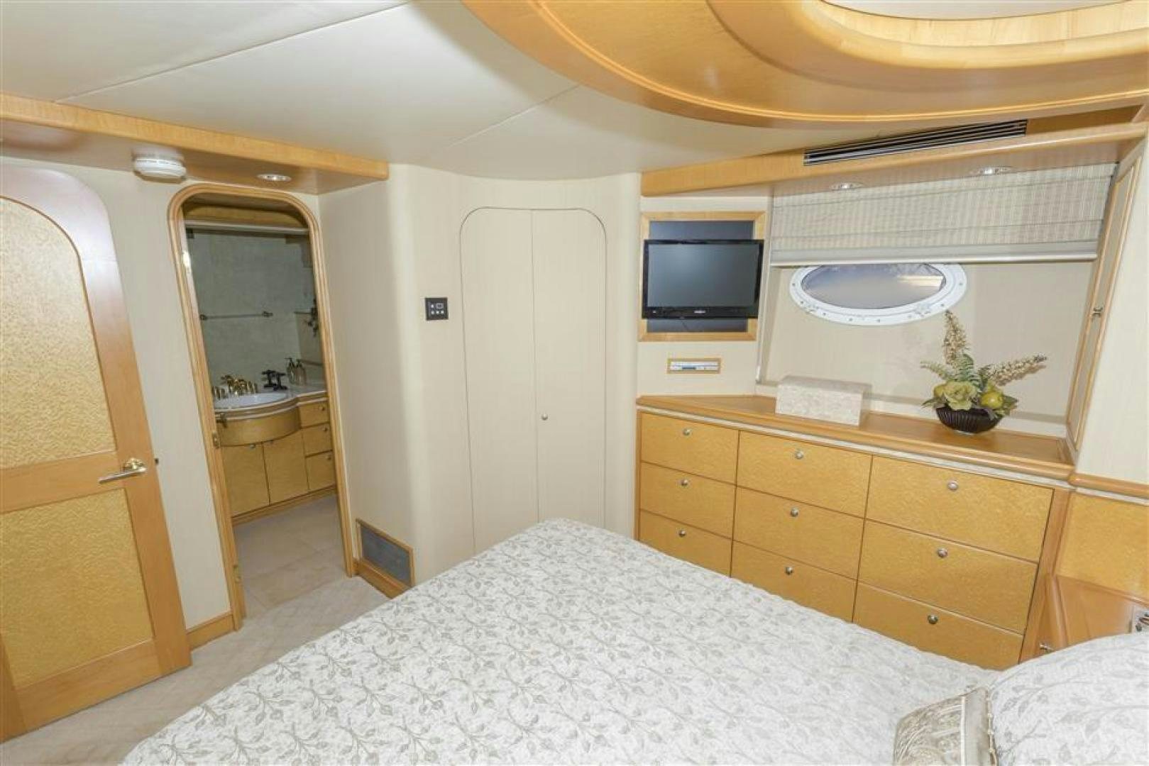 a bedroom with a bed and a television aboard DETERMINATION Yacht for Sale