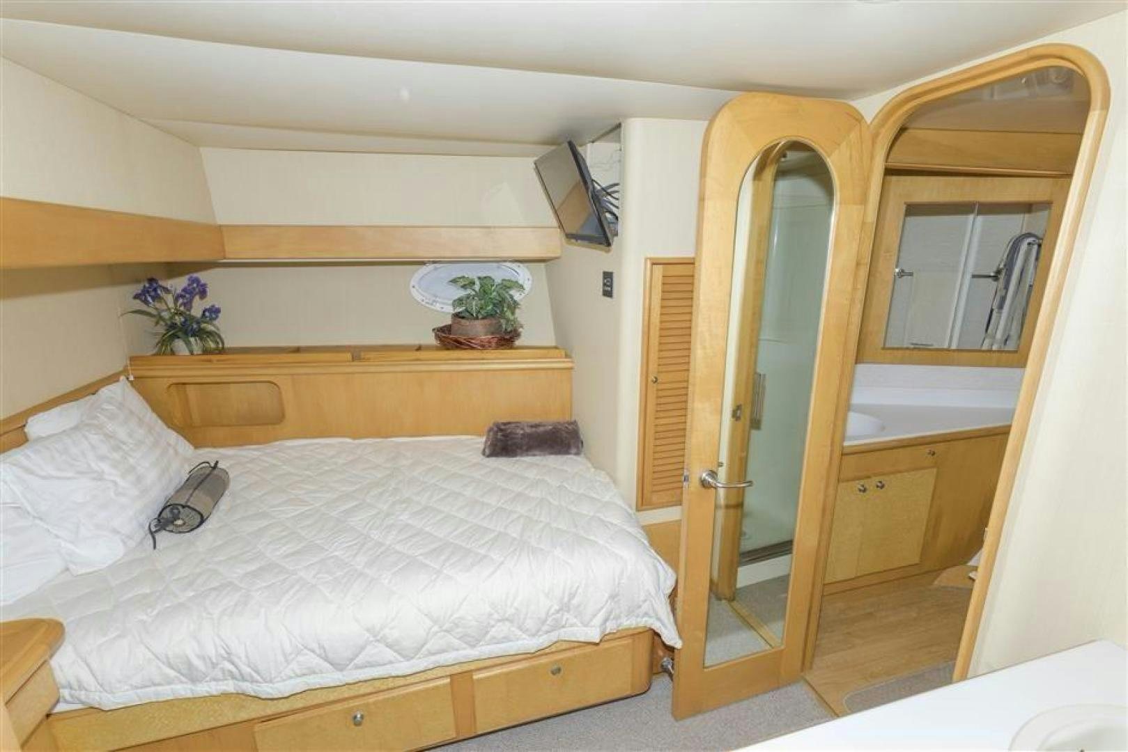 a bedroom with a bed and a desk aboard DETERMINATION Yacht for Sale