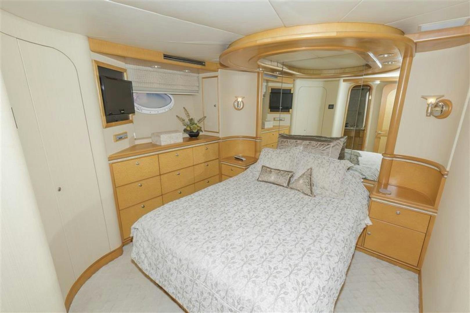 a bedroom with a bed and a dresser aboard DETERMINATION Yacht for Sale