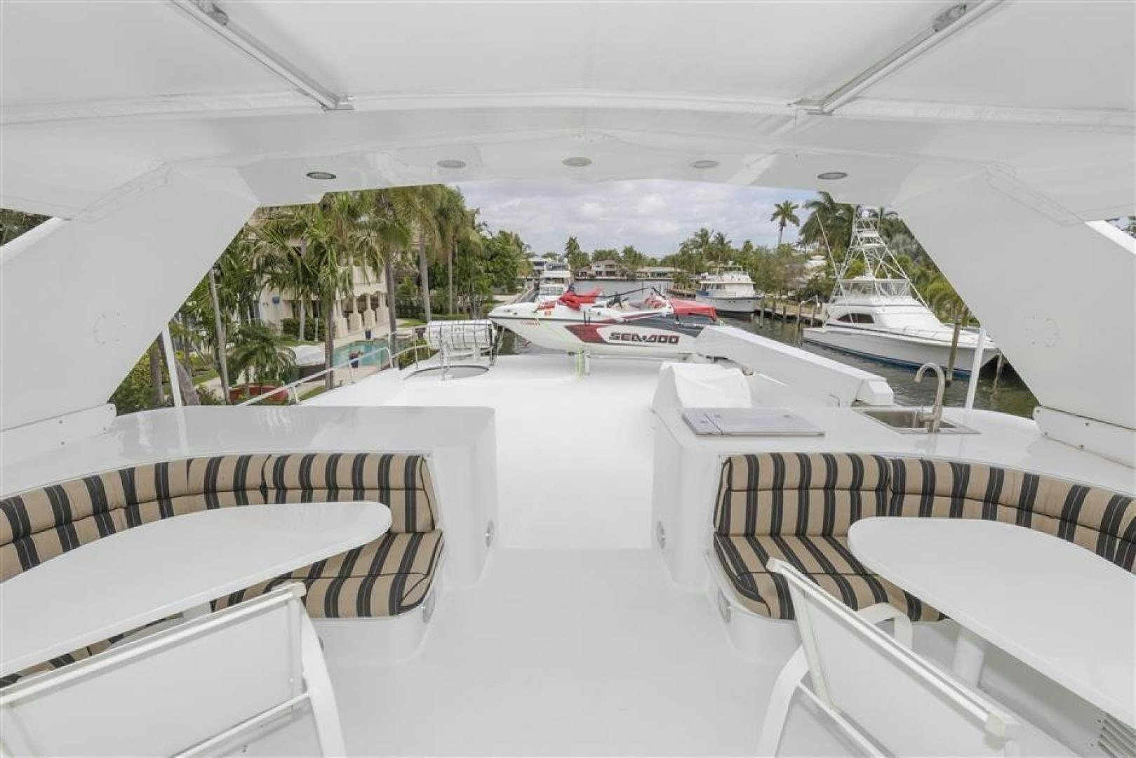 a rooftop with tables and chairs aboard DETERMINATION Yacht for Sale