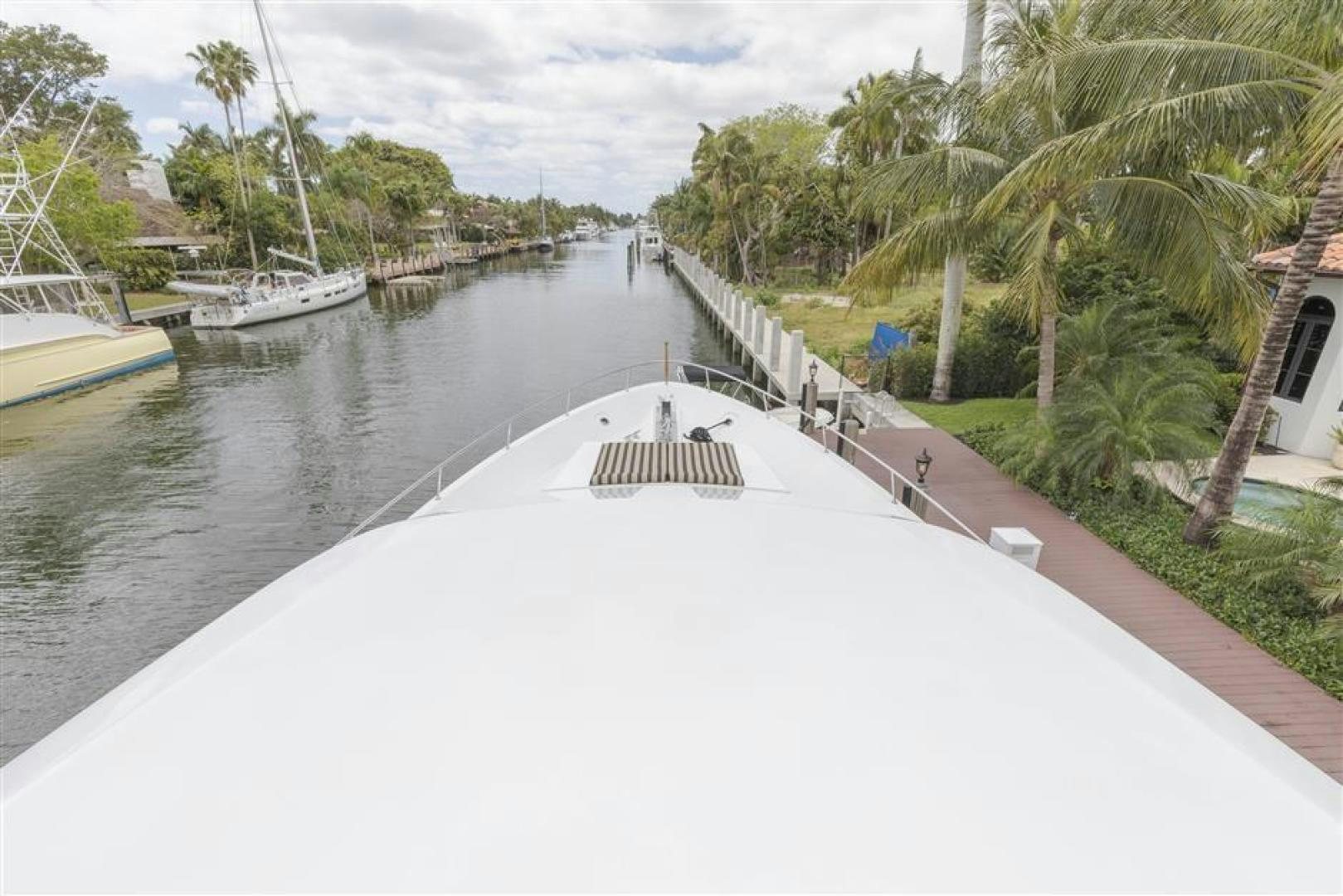 a white boat on a river aboard DETERMINATION Yacht for Sale