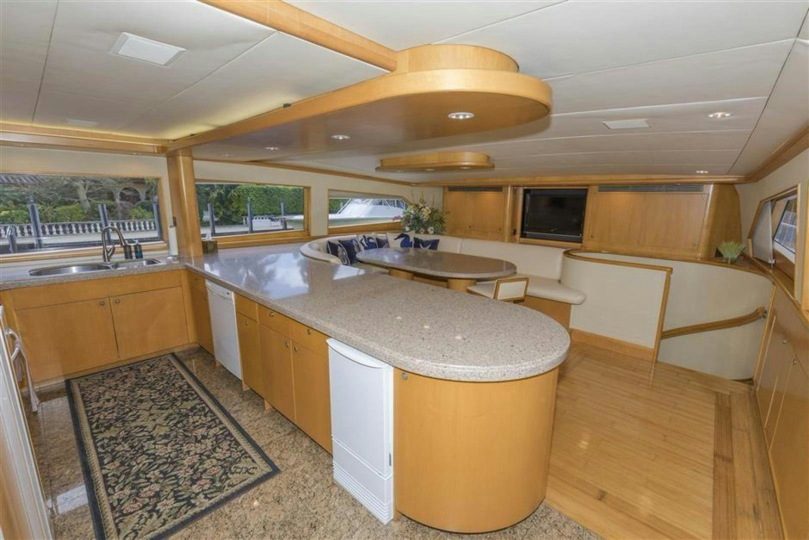 a large kitchen with a bar and a large island aboard DETERMINATION Yacht for Sale