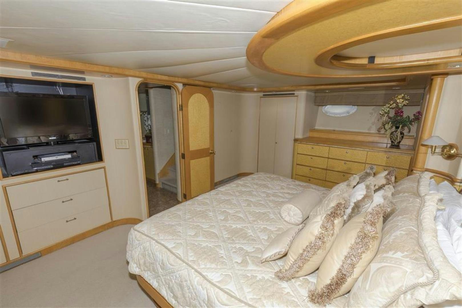 a bedroom with a bed and television aboard DETERMINATION Yacht for Sale