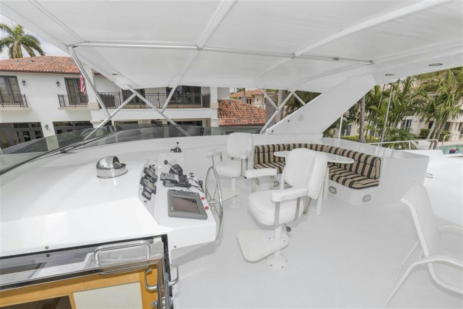 a white building with a balcony aboard DETERMINATION Yacht for Sale