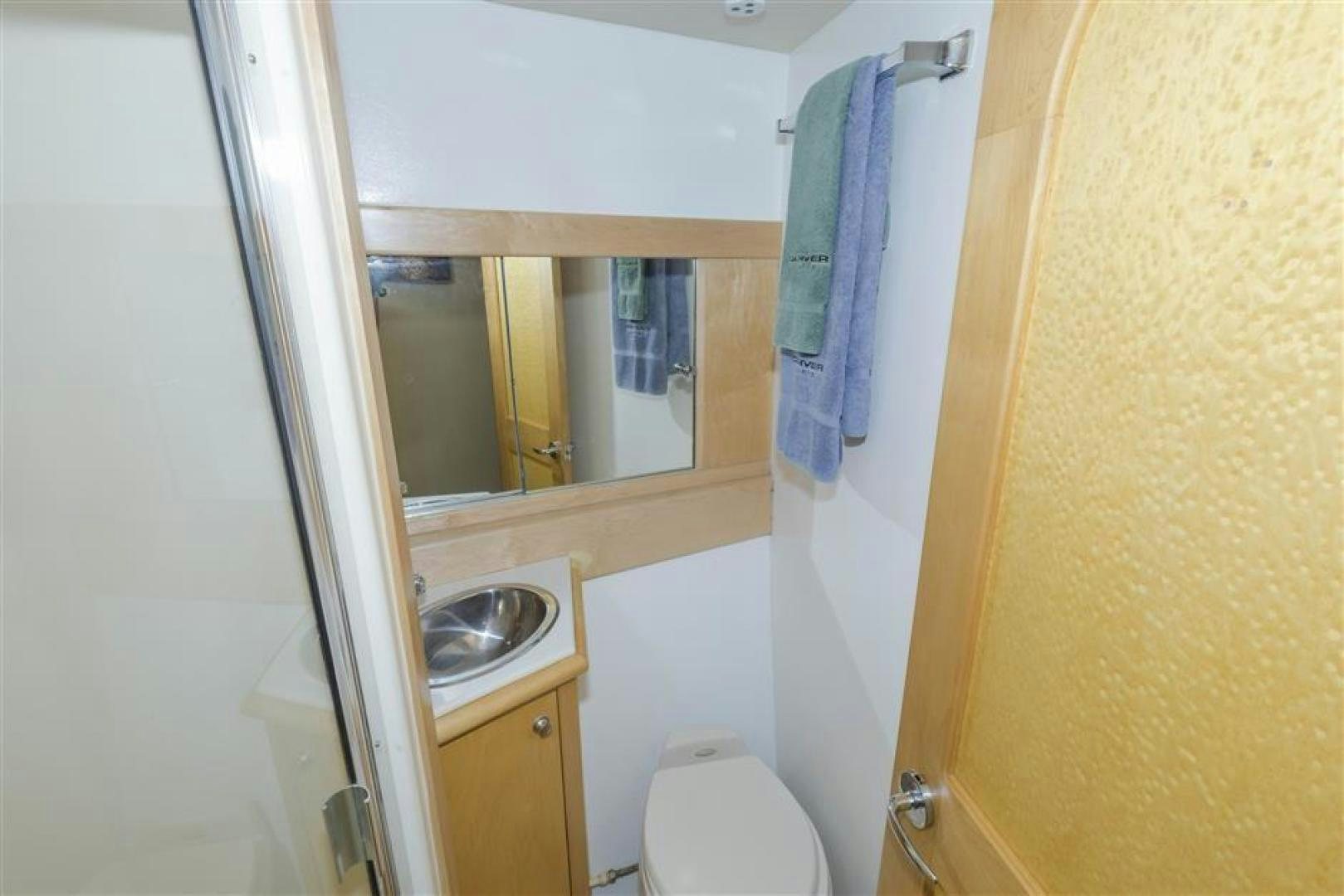 a bathroom with a sink and a toilet aboard DETERMINATION Yacht for Sale