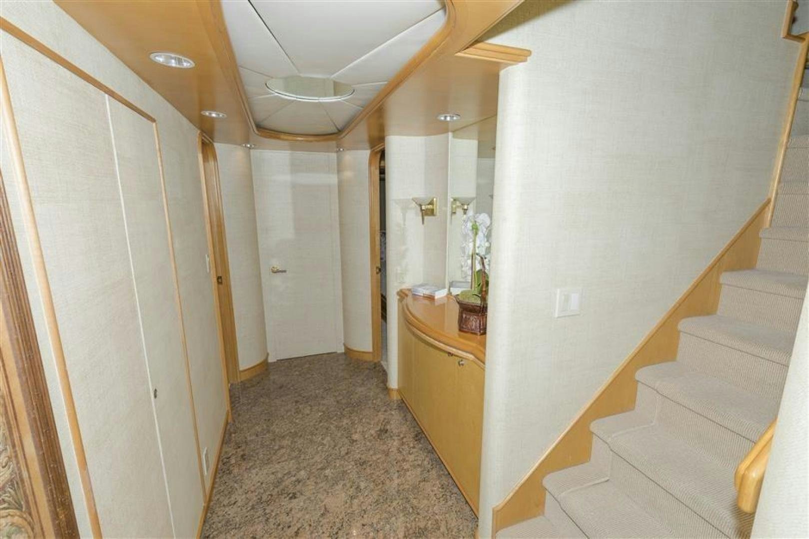 a hallway with a white wall and a tile floor aboard DETERMINATION Yacht for Sale