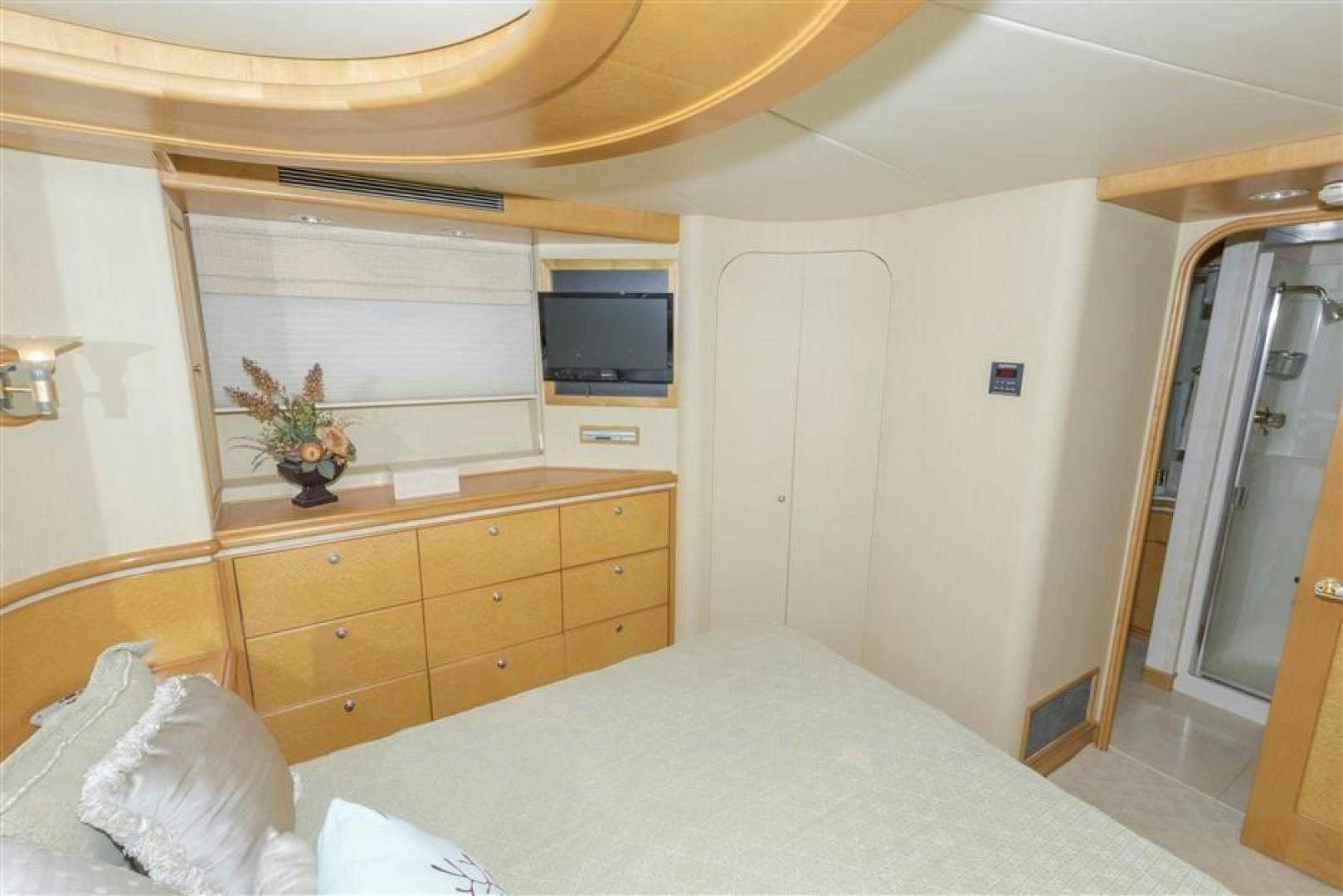 a bedroom with a bed and a television aboard DETERMINATION Yacht for Sale