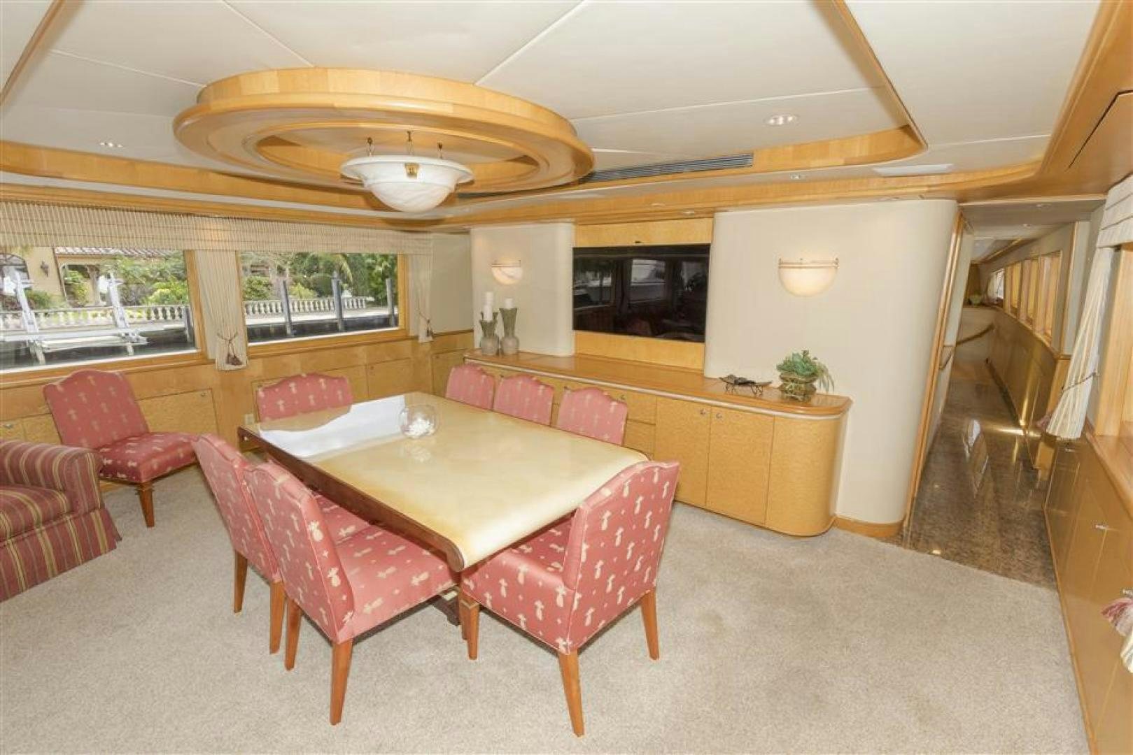 a large room with a table and chairs aboard DETERMINATION Yacht for Sale