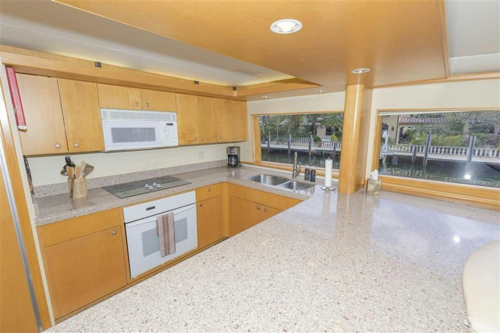 a kitchen with white appliances aboard DETERMINATION Yacht for Sale