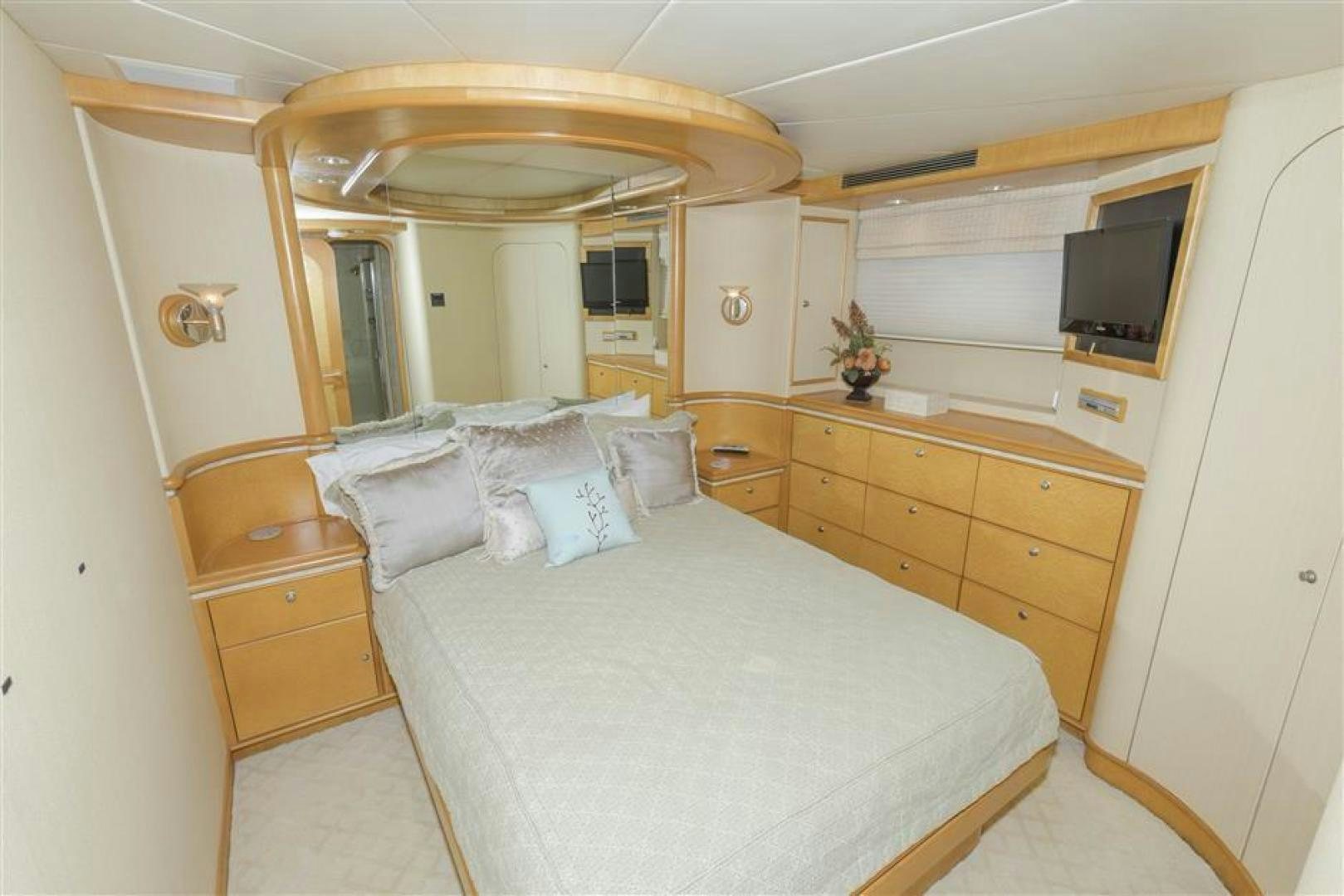 a bedroom with a bed and a dresser aboard DETERMINATION Yacht for Sale