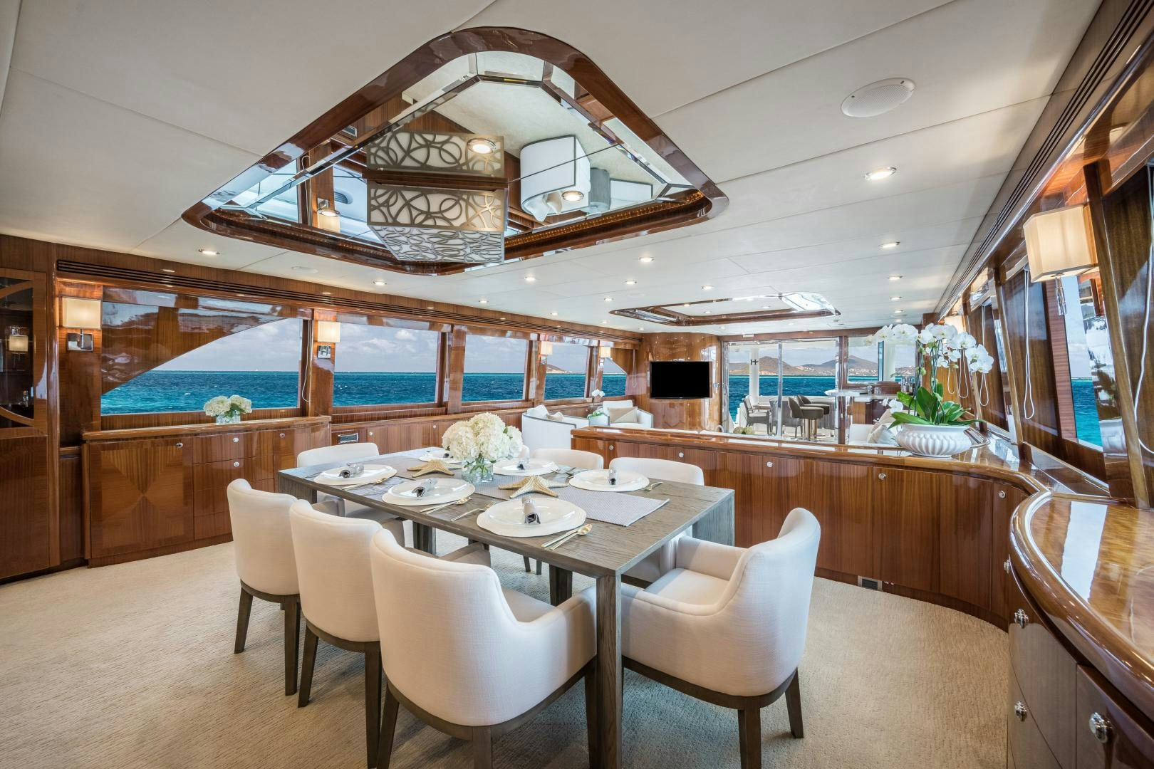 a large kitchen with a dining table aboard LIMITLESS Yacht for Sale