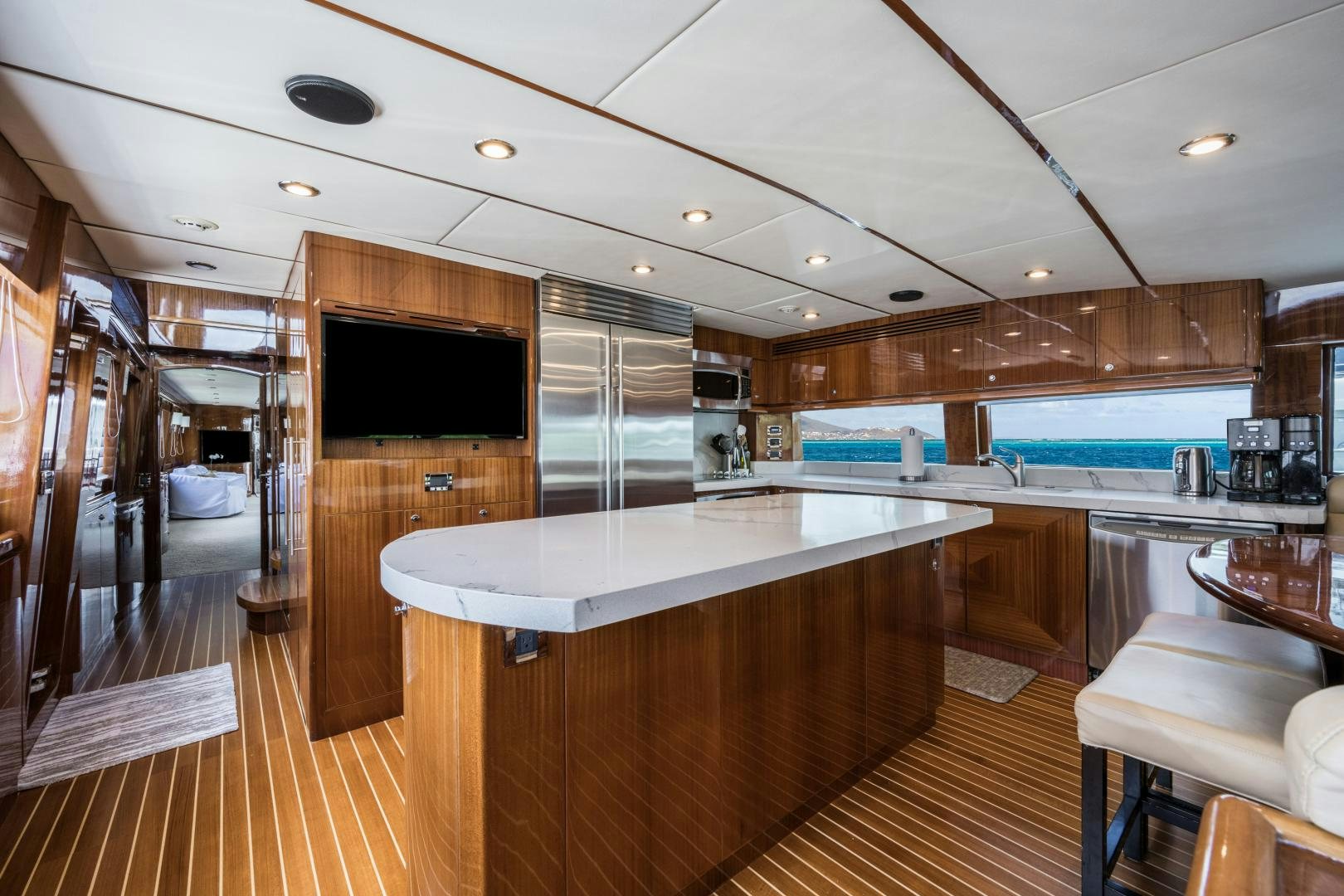 a large kitchen with a large bar aboard LIMITLESS Yacht for Sale